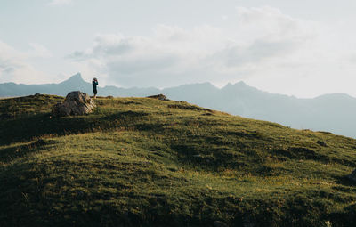 Man standing on mountain against sky