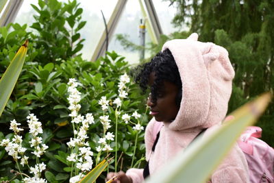 Woman looking at blooming flowers