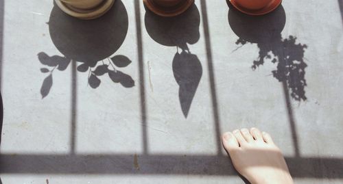 Low section of woman standing on wall