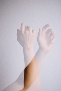 Double exposure of womans hands against white background