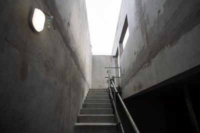 Low angle view of steps amidst buildings against clear sky