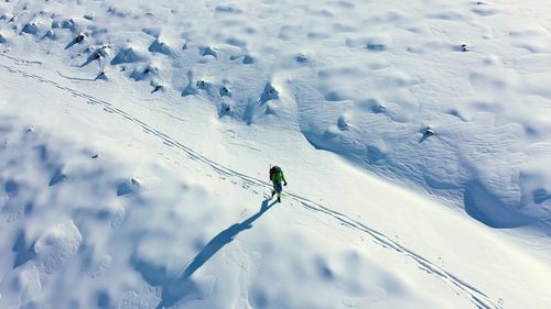 High angle view of person skiing on snow covered field