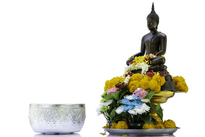 Statue of flower against white background