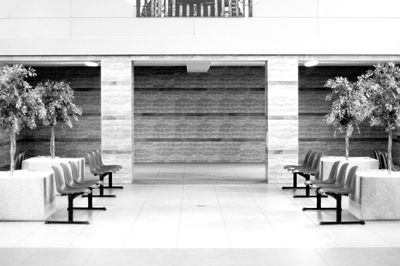 Empty chairs on floor in building