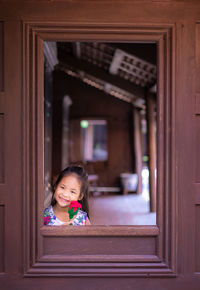 Cute girl looking through door