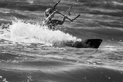 Woman kiteboarding on sea