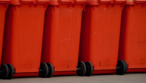 Close-up of objects against red wall