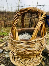 Close-up of wicker basket on field