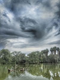 Scenic view of lake against dramatic sky