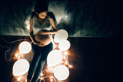 Reflection of woman on illuminated table