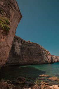 Scenic view of sea and mountains against clear sky