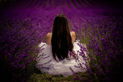 Rear view of woman with purple flowers