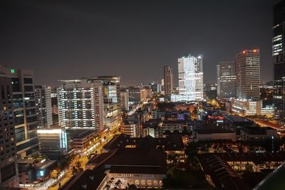 High angle view of illuminated buildings in city at night