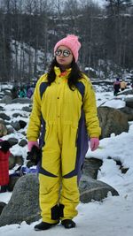 Full length of woman wearing hat standing in snow