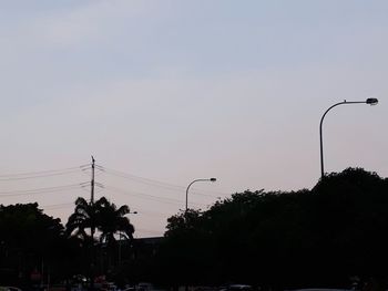 Low angle view of silhouette trees against clear sky