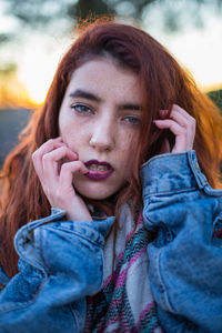 Portrait of young woman against sky during sunset