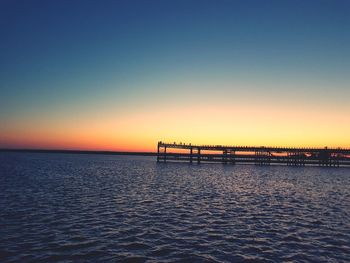 Scenic view of sea against clear sky during sunset