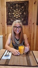 High angle view of young woman sitting on table