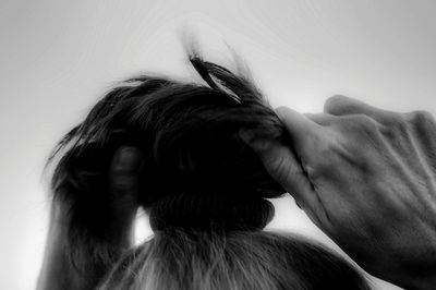 Woman tying ponytail