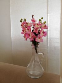 Close-up of pink roses in vase on table