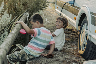 Two boys in a caravan playing in the nature