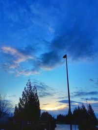 Low angle view of silhouette trees against sky during sunset