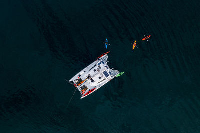 High angle view of people floating on sea