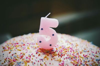 Close-up of number 5 candle on birthday cake