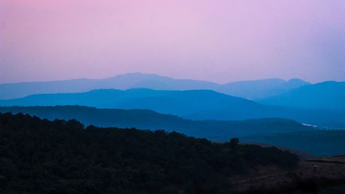 Scenic view of silhouette mountains against sky at sunset