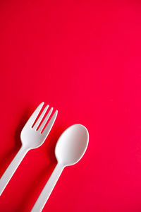 High angle view of coffee cup against red background