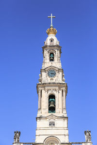 Low angle view of church against clear blue sky