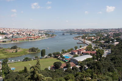 High angle view of townscape by river in city