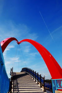 Low angle view of bridge against blue sky