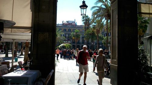 People in town square against sky