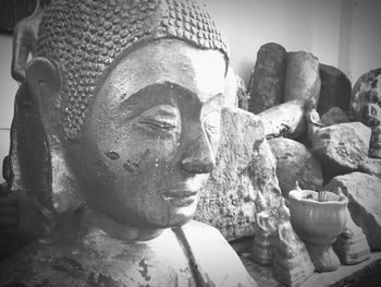 Close-up of buddha statue against building