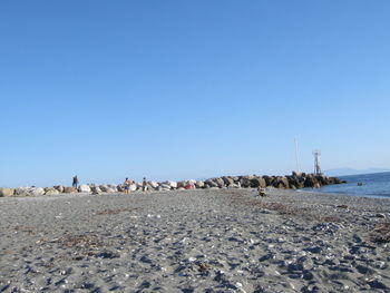 Scenic view of sandy beach against clear sky