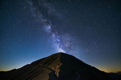 Scenic view of mountains against sky at night