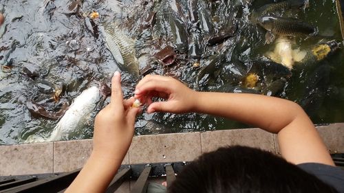 Close-up of hand with reflection in water