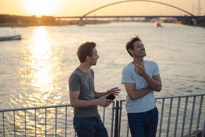 Two friends meeting at sunset, spending the evening talking