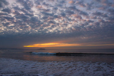 Scenic view of beach against sky during sunset