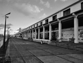 Empty street amidst buildings against sky