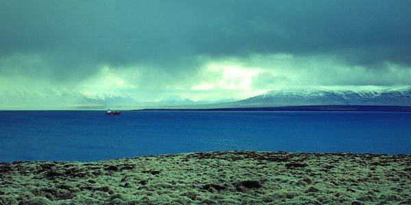 Scenic view of sea against storm clouds