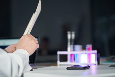 Cropped hand of doctor examining chemical in laboratory