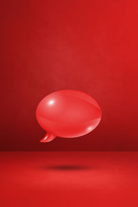 Low angle view of balloon against red background