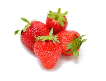 Close-up of strawberry over white background