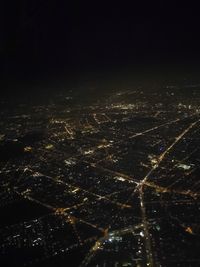 Aerial view of illuminated city at night