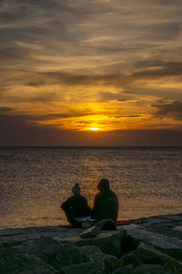 Couple at alling beach in sunset light, bornholm, denmark