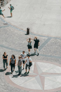 High angle view of people walking on street in city