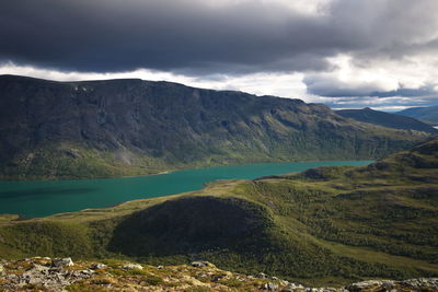 Scenic view of lake and mountains against sky