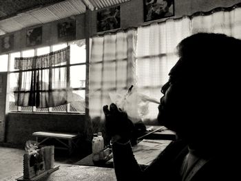 Close-up of man smoking in electronic cigarette